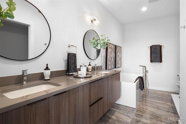 215 N Sarah St Unit 13, Saint Louis, MO 63108 - bathroom with double vanity, a bath, recessed lighting, toilet, and baseboards
