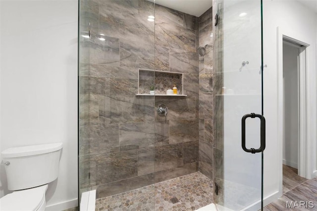 215 N Sarah St Unit 13, Saint Louis, MO 63108 - bathroom with baseboards, a stall shower, and toilet