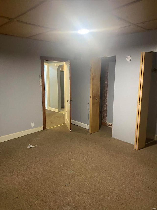 carpeted spare room with a smoke detector and baseboards