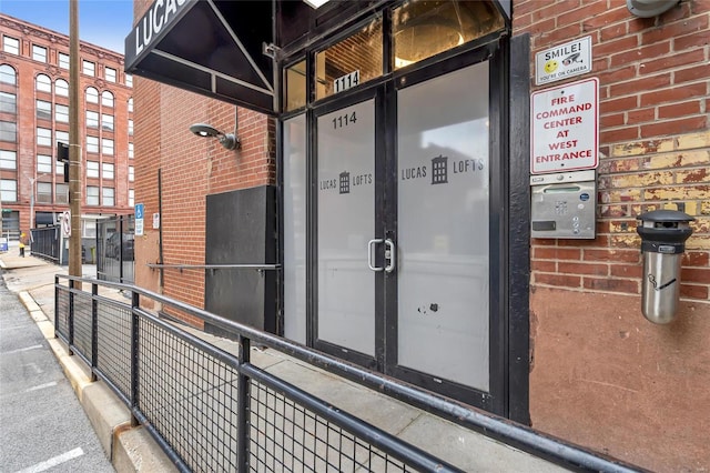 property entrance featuring brick siding