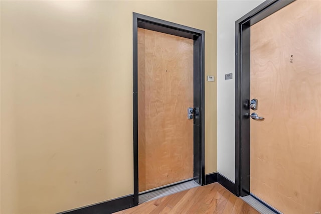 entryway with light wood-style floors and baseboards