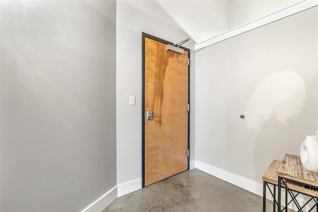 entrance foyer with finished concrete floors and baseboards