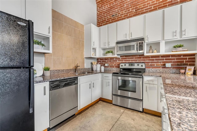 kitchen with open shelves, appliances with stainless steel finishes, and white cabinets