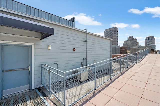 view of patio featuring a balcony and a city view