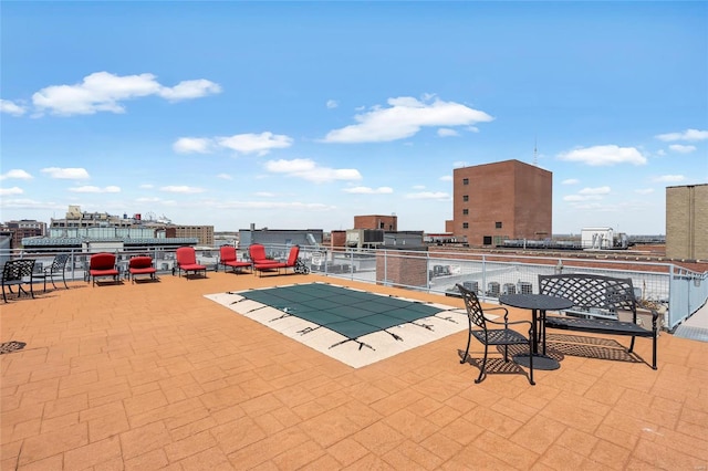 view of pool featuring a patio area and a city view