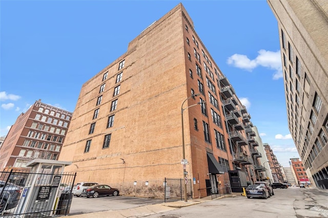 view of apartment building / complex with uncovered parking