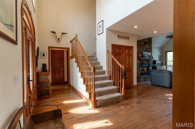13112 Heritage Ln, Pocahontas, IL 62275 - foyer featuring stairway, wood finished floors, a fireplace, high vaulted ceiling, and recessed lighting