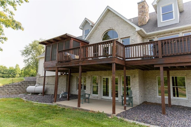 13112 Heritage Ln, Pocahontas, IL 62275 - back of house with brick siding, a patio, a wooden deck, and a lawn
