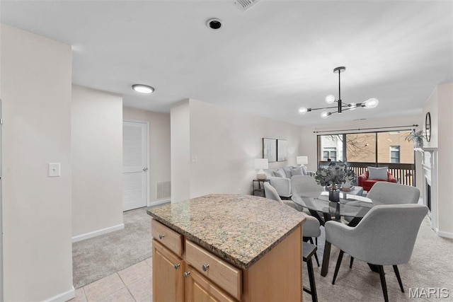 950 E Rue De La Banque Unit 110, Creve Coeur, MO 63141 - kitchen with light carpet, baseboards, a center island, a chandelier, and open floor plan