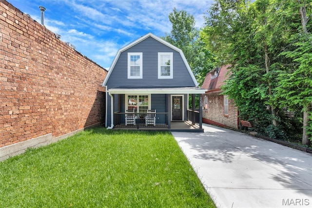 3258 Walter Ave, Saint Louis, MO 63143 - rear view of house with covered porch, a gambrel roof, and a lawn