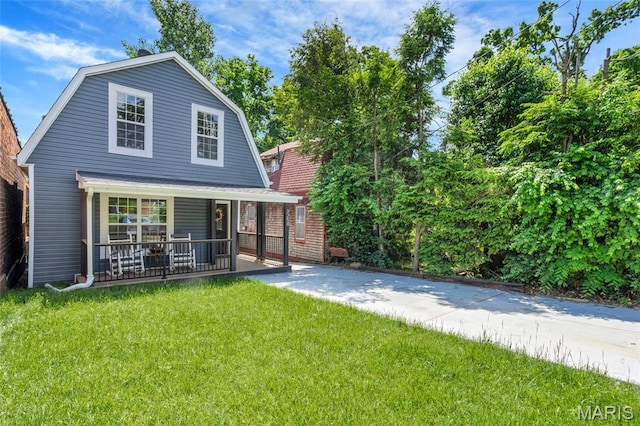 3258 Walter Ave, Saint Louis, MO 63143 - rear view of property featuring a porch, a gambrel roof, and a yard