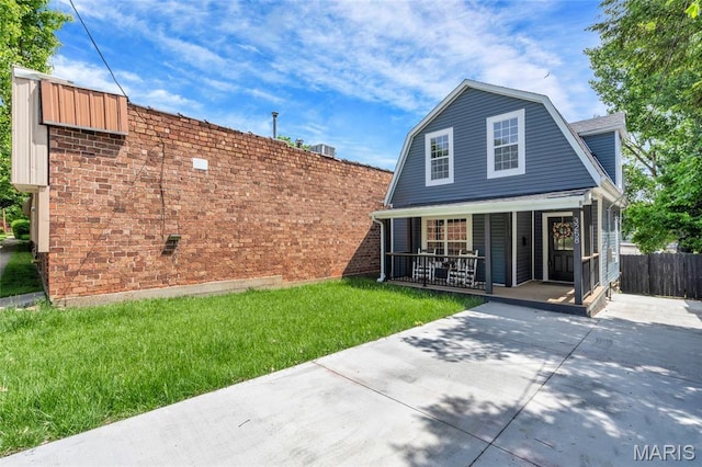 3258 Walter Ave, Saint Louis, MO 63143 - back of house with a porch and a gambrel roof