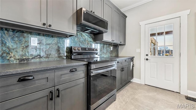 3258 Walter Ave, Saint Louis, MO 63143 - kitchen with stainless steel appliances, gray cabinetry, crown molding, backsplash, and baseboards