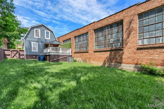 3258 Walter Ave, Saint Louis, MO 63143 - back of property with central air condition unit, a wooden deck, a gambrel roof, and brick siding