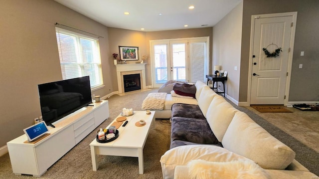 carpeted living room with plenty of natural light, recessed lighting, baseboards, and a fireplace with flush hearth