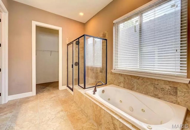 6416 Cates Ave, Saint Louis, MO 63130 - bathroom featuring a stall shower, a whirlpool tub, a spacious closet, and healthy amount of natural light