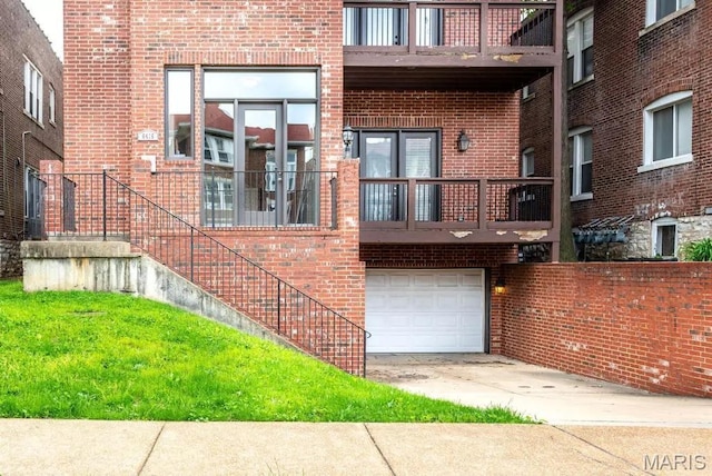6416 Cates Ave, Saint Louis, MO 63130 - exterior space featuring a garage, a balcony, brick siding, and concrete driveway