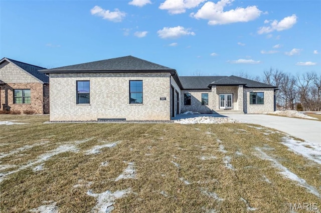 600 Legacy Dr, Waterloo, IL 62298 - rear view of property featuring brick siding, a lawn, and driveway
