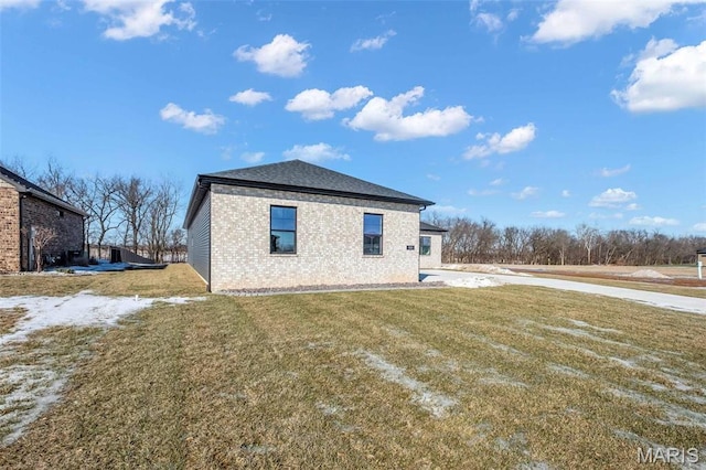 600 Legacy Dr, Waterloo, IL 62298 - view of property exterior featuring brick siding, a lawn, and concrete driveway