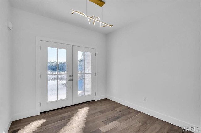 600 Legacy Dr, Waterloo, IL 62298 - empty room with french doors, wood finished floors, baseboards, a chandelier, and a water view