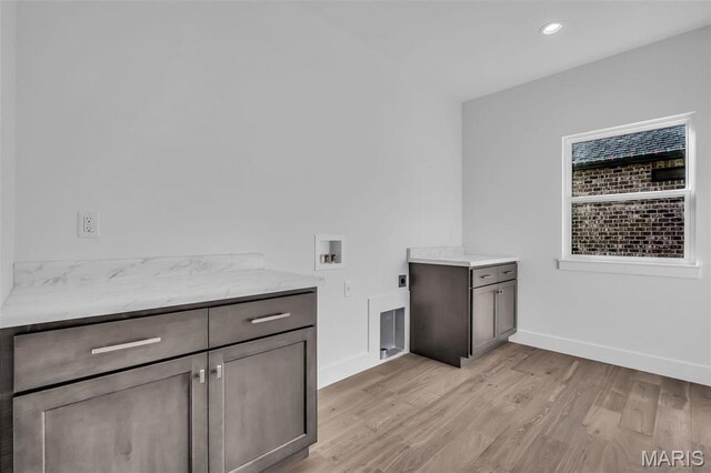 600 Legacy Dr, Waterloo, IL 62298 - washroom featuring cabinet space, hookup for a washing machine, light wood finished floors, baseboards, and electric dryer hookup