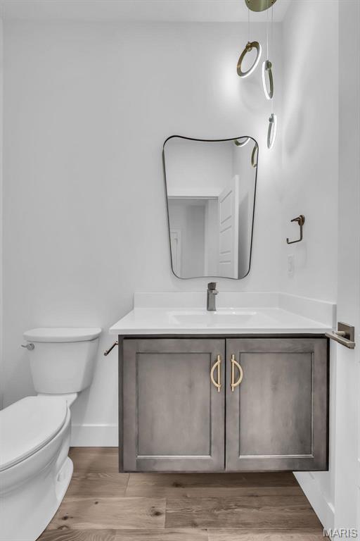 600 Legacy Dr, Waterloo, IL 62298 - bathroom with vanity, toilet, baseboards, and wood finished floors