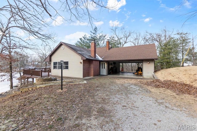 520 Christopher Dr, Perryville, MO 63775 - view of front of house with driveway, a chimney, an attached carport, and a deck