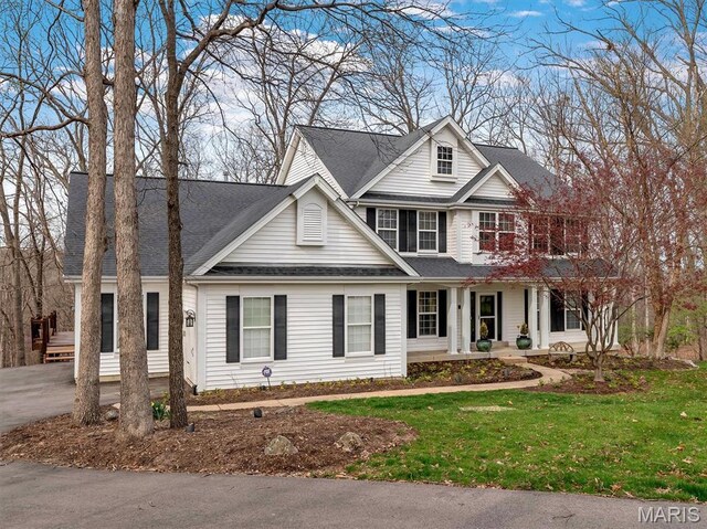 997 Sheffield Forest Ct, Wildwood, MO 63021 - traditional-style house featuring a porch, a front yard, and roof with shingles