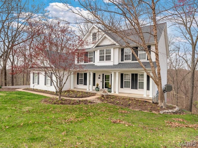 997 Sheffield Forest Ct, Wildwood, MO 63021 - view of front of home featuring covered porch, a front lawn, and central AC