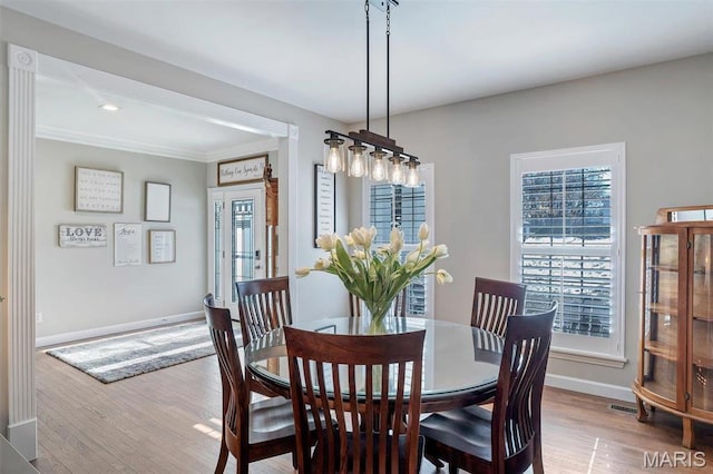997 Sheffield Forest Ct, Wildwood, MO 63021 - dining space featuring wood finished floors, baseboards, and ornamental molding