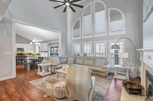 997 Sheffield Forest Ct, Wildwood, MO 63021 - living area with high vaulted ceiling, a chandelier, plenty of natural light, a glass covered fireplace, and a ceiling fan