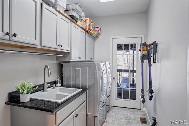 997 Sheffield Forest Ct, Wildwood, MO 63021 - laundry room with washer and clothes dryer, cabinet space, and baseboards