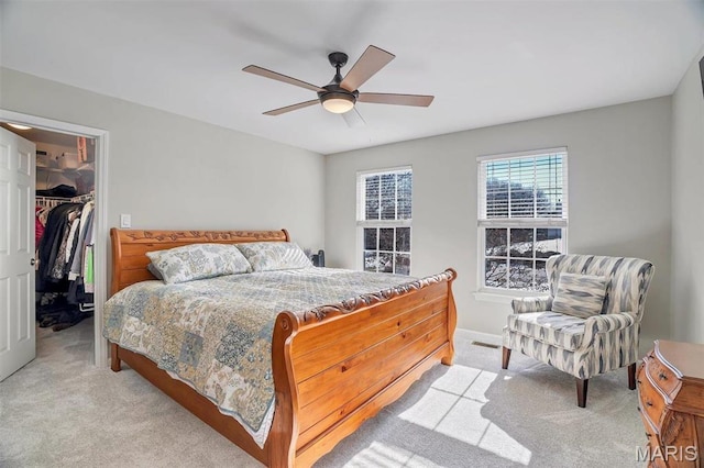 997 Sheffield Forest Ct, Wildwood, MO 63021 - bedroom featuring light colored carpet, a walk in closet, a closet, a ceiling fan, and baseboards
