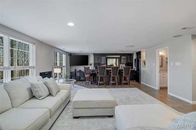 997 Sheffield Forest Ct, Wildwood, MO 63021 - living room with light tile patterned floors, baseboards, and recessed lighting