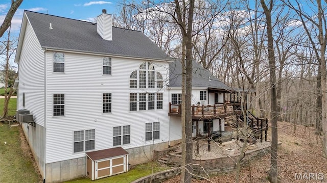 997 Sheffield Forest Ct, Wildwood, MO 63021 - back of property featuring a chimney, a wooden deck, a shingled roof, and cooling unit