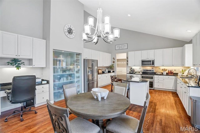 997 Sheffield Forest Ct, Wildwood, MO 63021 - dining space with high vaulted ceiling, a chandelier, light wood-style floors, and an office area