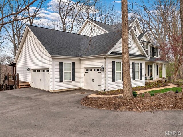 997 Sheffield Forest Ct, Wildwood, MO 63021 - view of front of house with a shingled roof, a garage, and asphalt driveway
