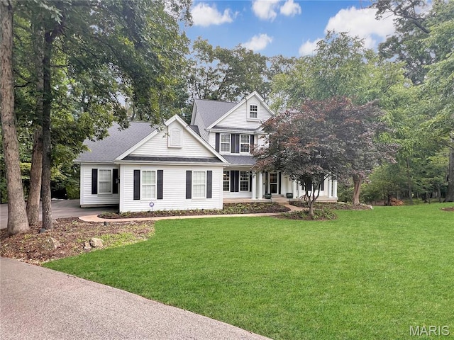 997 Sheffield Forest Ct, Wildwood, MO 63021 - view of front of home featuring a front yard, covered porch, and roof with shingles