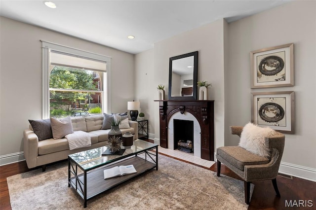 2811 Shenandoah Ave, Saint Louis, MO 63104 - living room featuring wood finished floors, a fireplace with flush hearth, and recessed lighting
