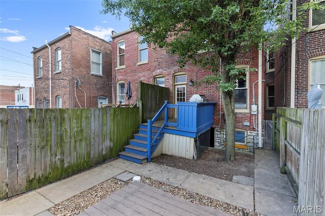 2811 Shenandoah Ave, Saint Louis, MO 63104 - back of house with brick siding and a wooden deck
