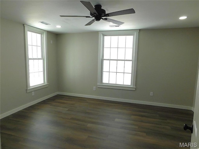 unfurnished room with healthy amount of natural light, dark wood-style floors, baseboards, recessed lighting, and ceiling fan