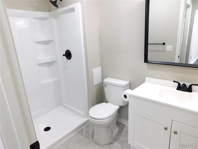 bathroom featuring baseboards, a shower stall, vanity, and marble finish flooring