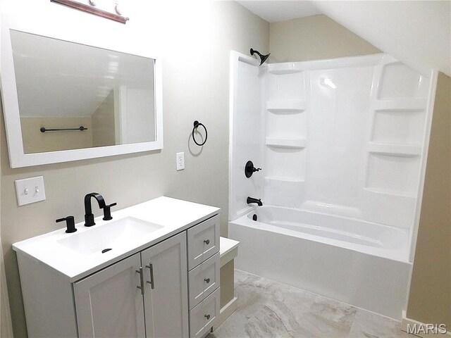 full bathroom with bathing tub / shower combination, marble look tile flooring, and vanity