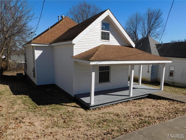 back of property featuring roof with shingles and covered porch