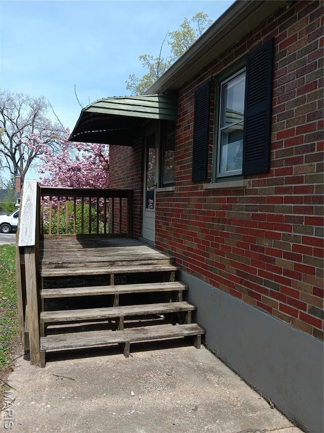 9100 Gedde Ave, Saint Louis, MO 63134 - doorway to property featuring brick siding and a wooden deck