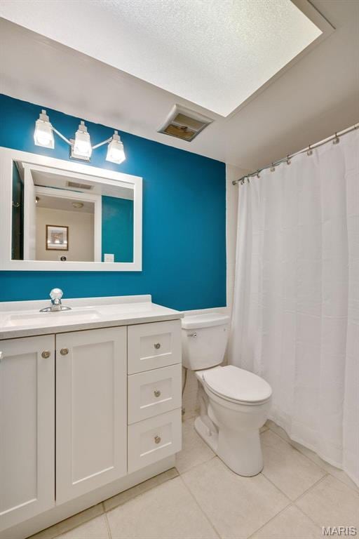 13485 Coliseum Dr Unit G, Chesterfield, MO 63017 - full bathroom featuring tile patterned flooring, toilet, vanity, and a textured ceiling