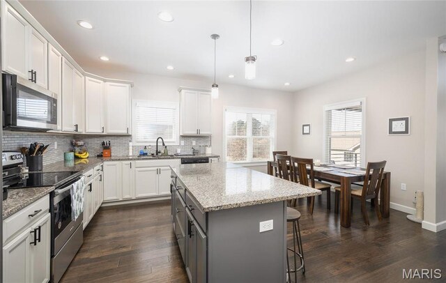 1201 Aster Ct, St James, MO 65559 - kitchen with stainless steel appliances, a sink, a center island, decorative backsplash, and recessed lighting