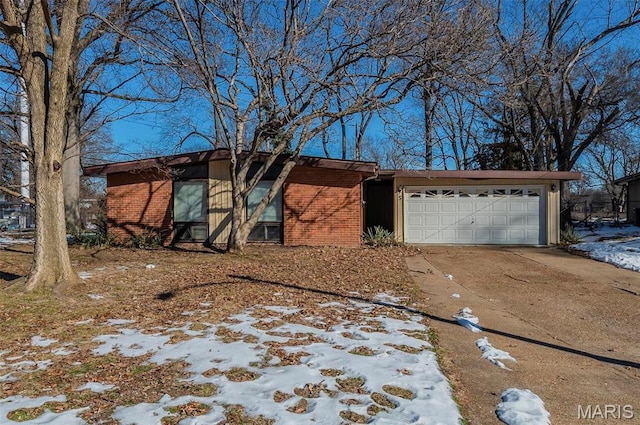5 Little Ln, Florissant, MO 63033 - view of front facade featuring brick siding, a garage, and concrete driveway