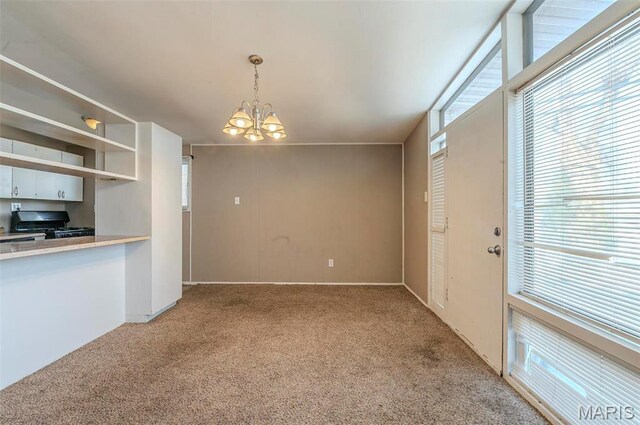 5 Little Ln, Florissant, MO 63033 - kitchen with light colored carpet, a chandelier, black gas stove, and light countertops