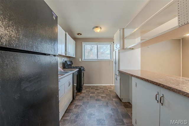 5 Little Ln, Florissant, MO 63033 - kitchen featuring freestanding refrigerator, range with gas cooktop, stone finish flooring, open shelves, and white cabinetry